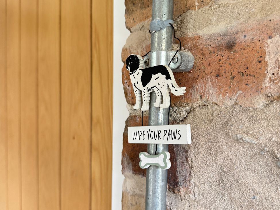 A dog sign with an instruction in a rustic setting at Railway Cottage Penybontfawr