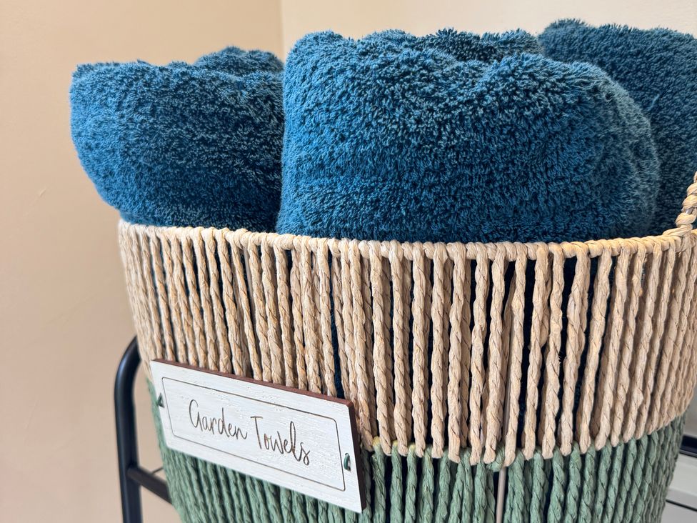 A basket with garden towels at Railway Cottage Penybontfawr