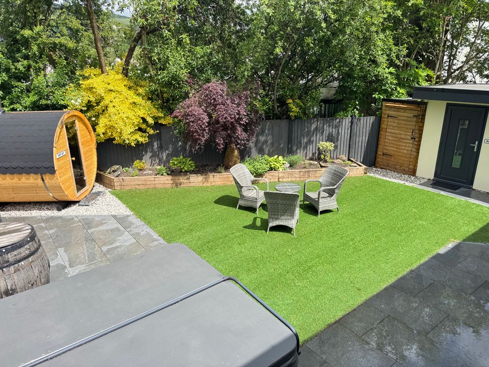 A garden with furniture at Railway Cottage in Penybontfawr