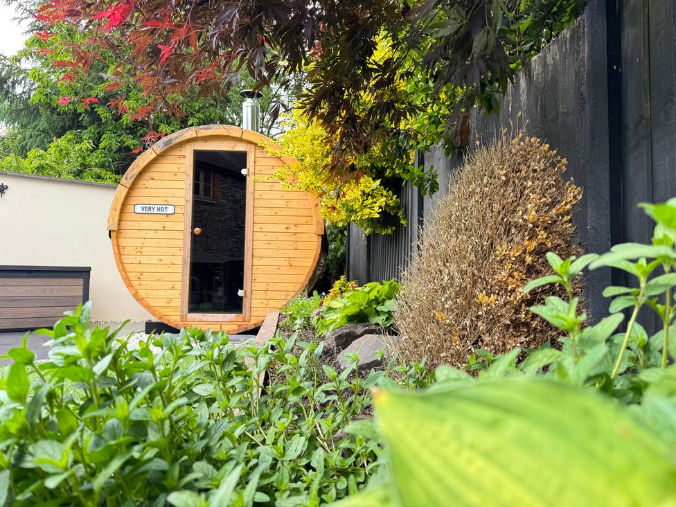 A wooden sauna in a garden at Railway Cottage in Penybontfawr