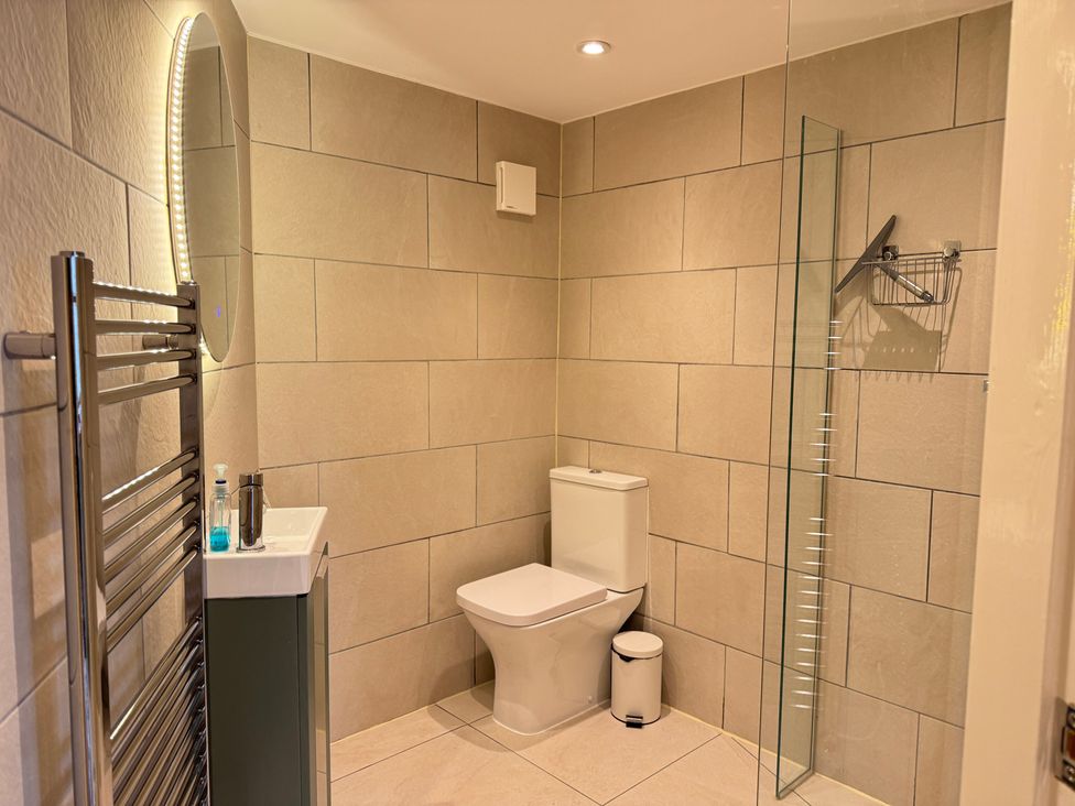 A bathroom with a toilet and sink at Railway Cottage in Penybontfawr
