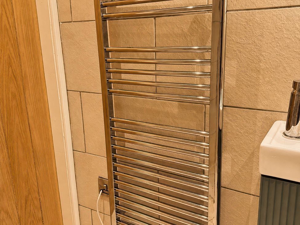 A towel radiator mounted on the wall at Railway Cottage Penybontfawr