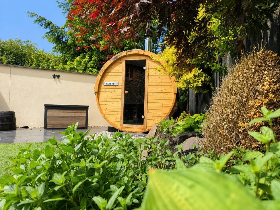 A wooden sauna in a garden at Railway Cottage Penybontfawr