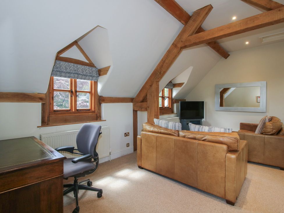 A snug with a desk and sofa at Pultheley Cottage Hyssington near Churchstoke