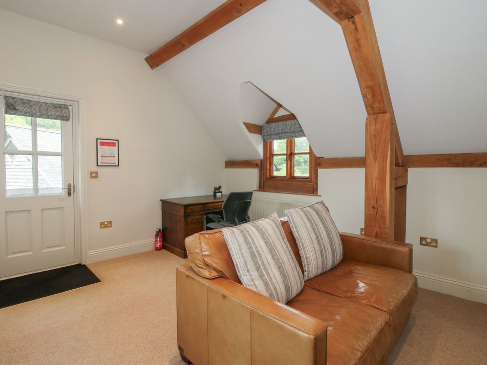A snug with a desk and an armchair at Pultheley Cottage Hyssington near Churchstoke