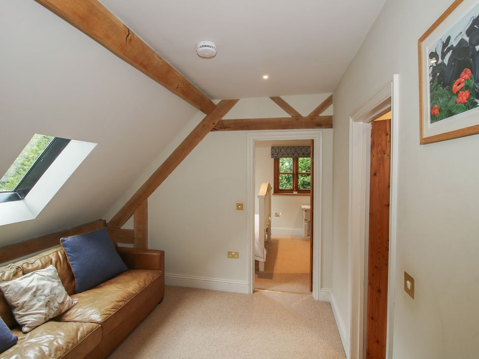 A living room with a sofa and artwork at Pultheley Cottage Hyssington near Churchstoke