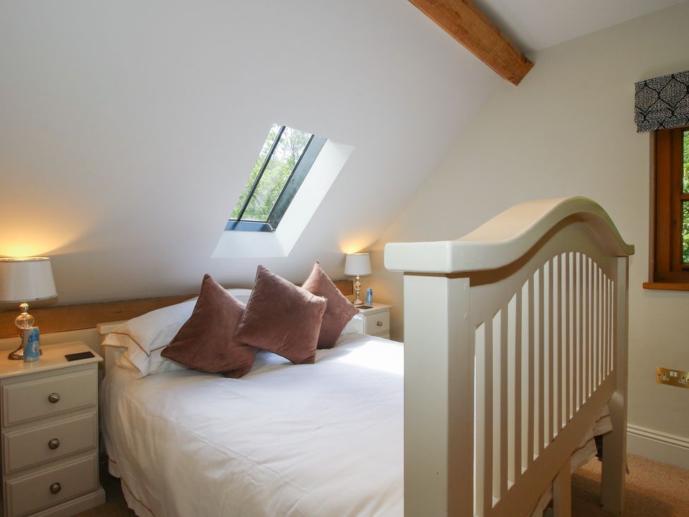 A bedroom with a bed and bedside tables at Pultheley Cottage in Hyssington near Churchstoke