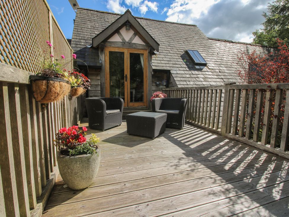 An outdoor seating area with chairs and a table at Pultheley Cottage in Hyssington near Churchstoke