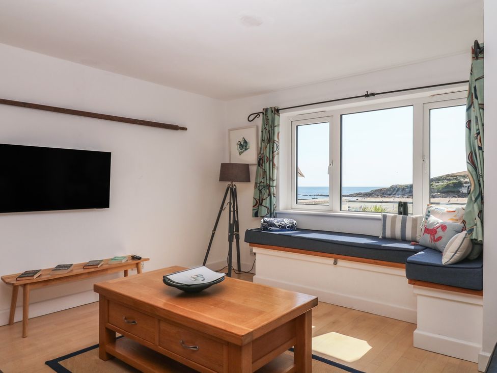 A living room with a window seat and television at 4 Burgh Island Causeway Bigbury
