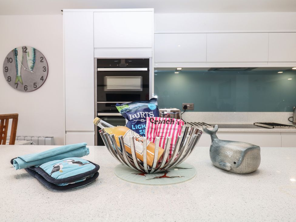 A kitchen with a table and fruit bowl at 4 Burgh Island Causeway in Bigbury