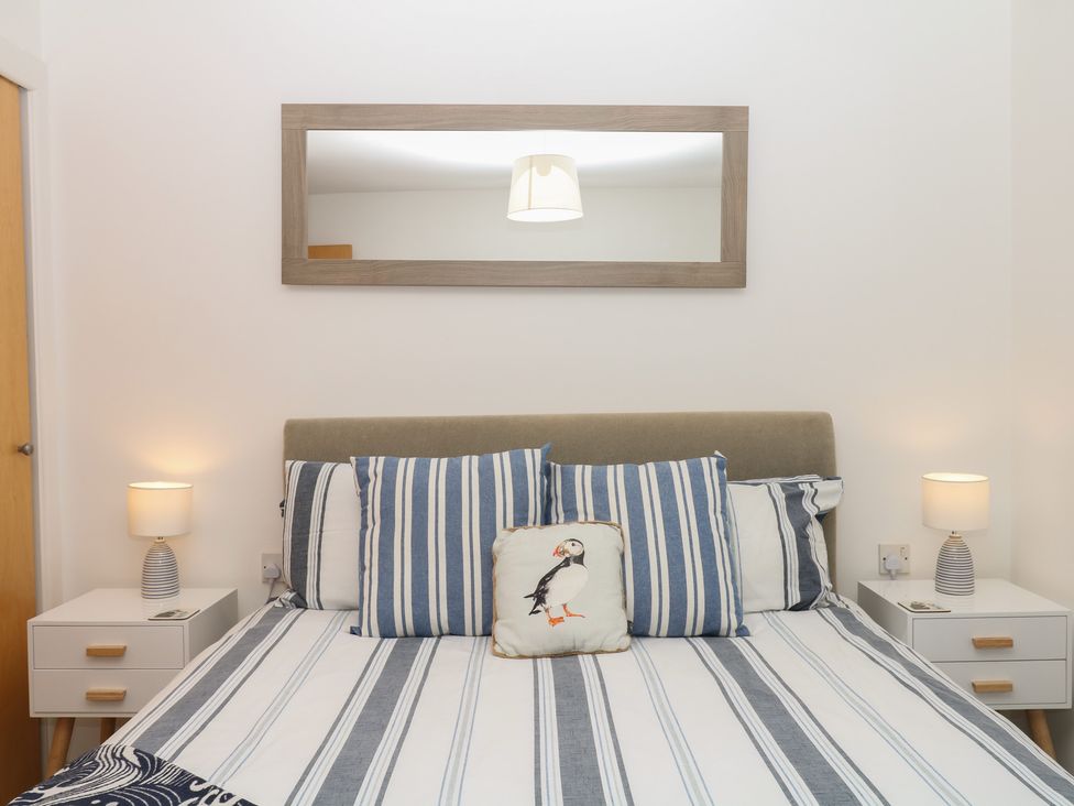 A bedroom with a bed and pillows at 4 Burgh Island Causeway Bigbury