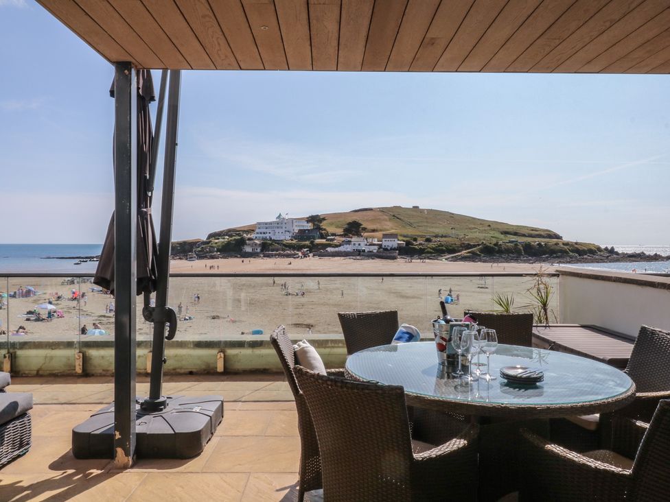 An outdoor patio with a view of the beach and ocean at 4 Burgh Island Causeway in Bigbury
