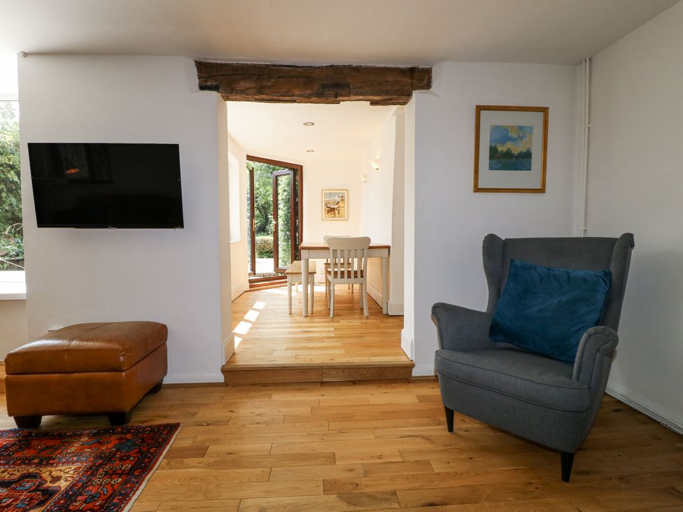 A living room with a television and an armchair at 35 Main Street in Gunthorpe near Lowdham