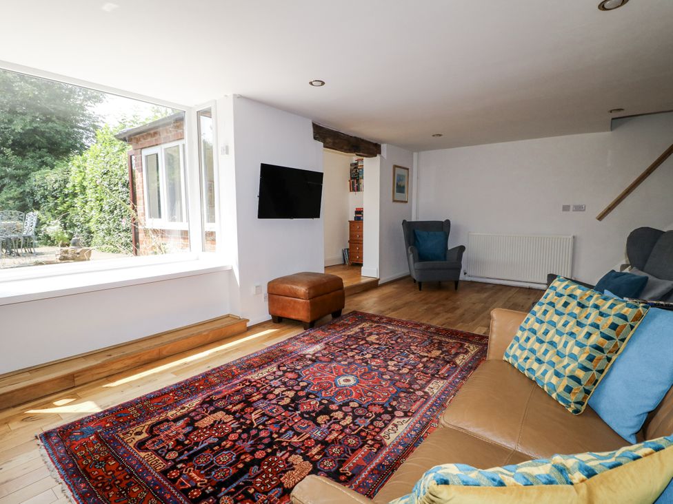 A living room with a sofa and television at 35 Main Street in Gunthorpe near Lowdham