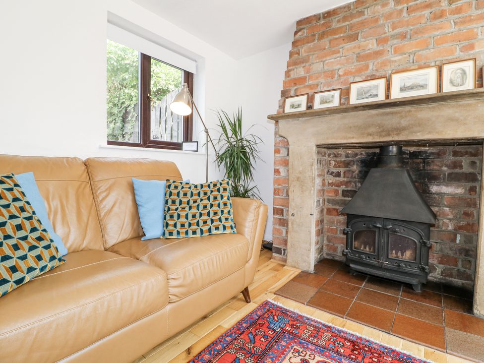 A living room with a sofa and fireplace at 35 Main Street Gunthorpe near Lowdham