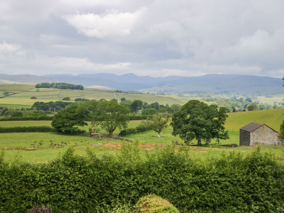 A landscape with trees and a stone building at Fell View Cottage, Lambrigg near Kendal
