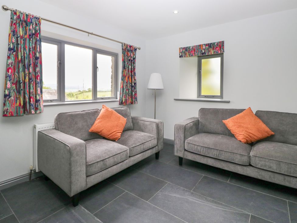 A living room with two sofas and a lamp at Fell View Cottage Lambrigg near Kendal