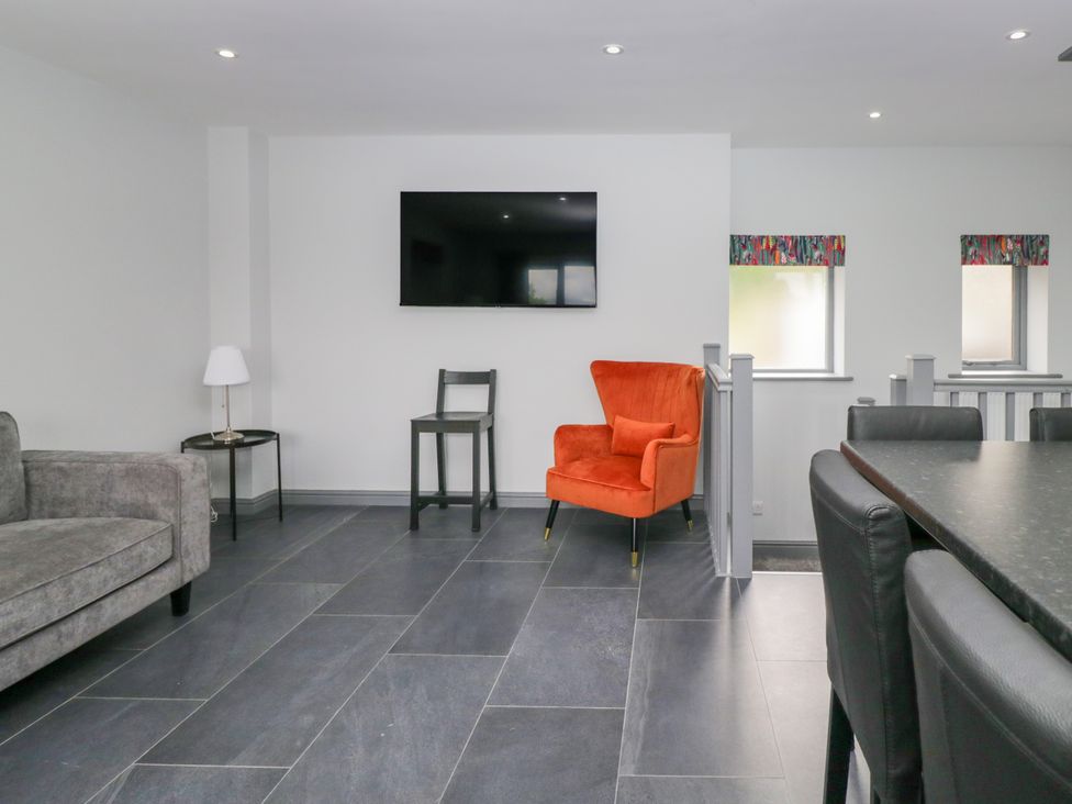 A living room with a sofa and television at Fell View Cottage Lambrigg near Kendal