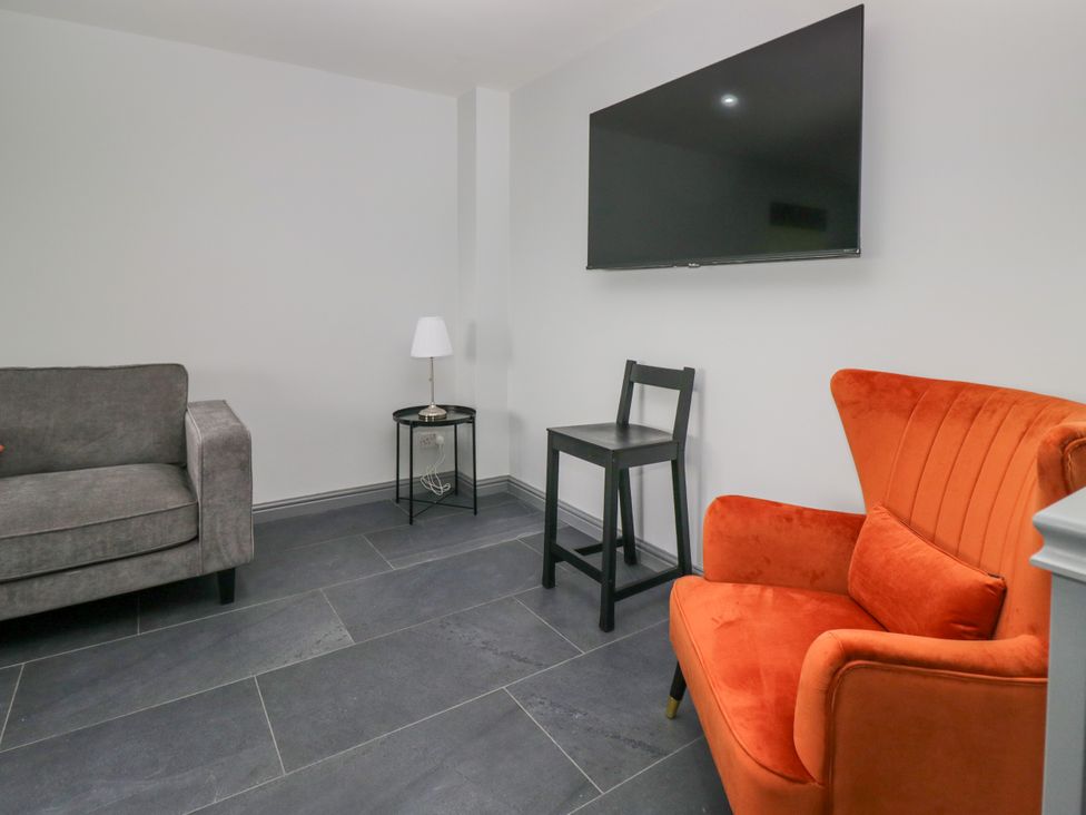 A living room with a television and seating at Fell View Cottage Lambrigg near Kendal