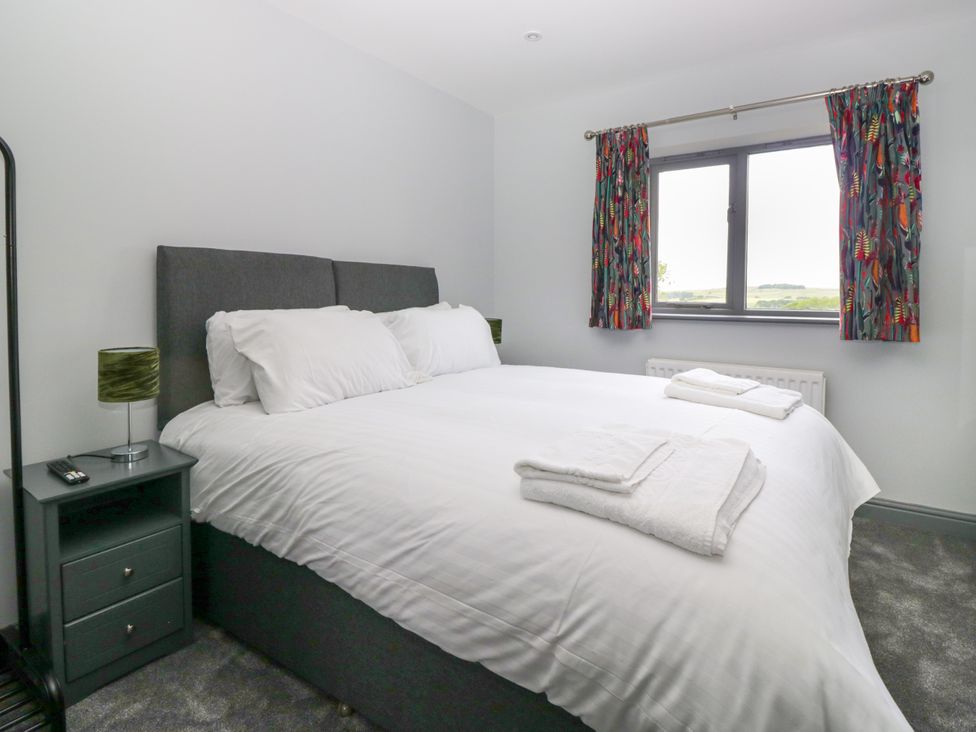 A bedroom with a bed and a bedside table at Fell View Cottage Lambrigg near Kendal