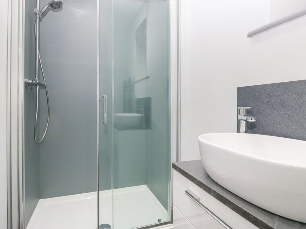 A bathroom with a shower and basin at Fell View Cottage in Lambrigg near Kendal