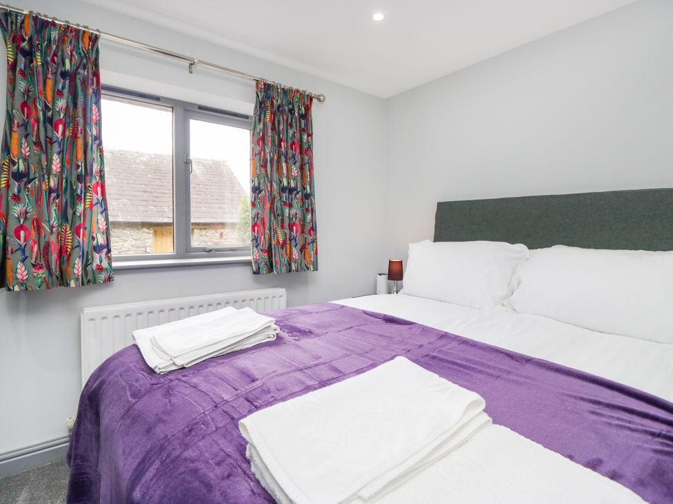 A bedroom with a bed and a window at Fell View Cottage in Lambrigg near Kendal