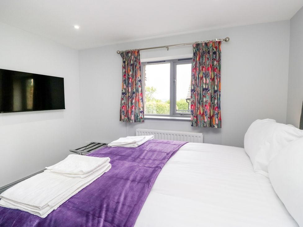 A bedroom with a bed and a television at Fell View Cottage in Lambrigg near Kendal