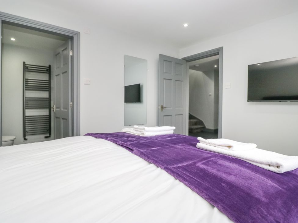 A bedroom with a bed and television at Fell View Cottage in Lambrigg near Kendal