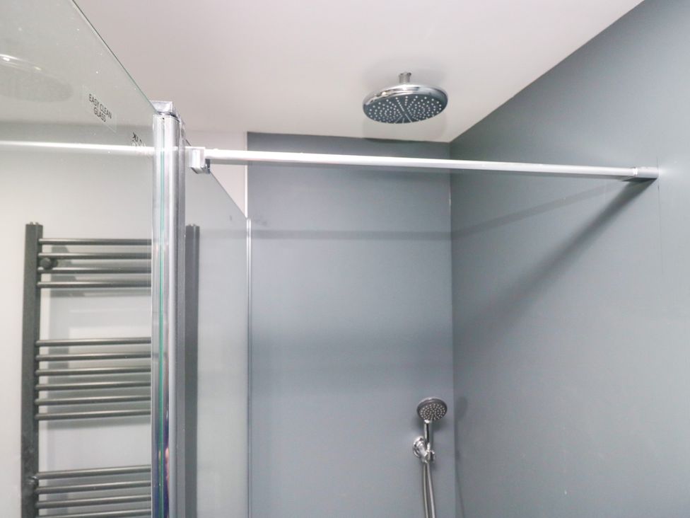A shower area with a showerhead and towel rail at Fell View Cottage Lambrigg near Kendal