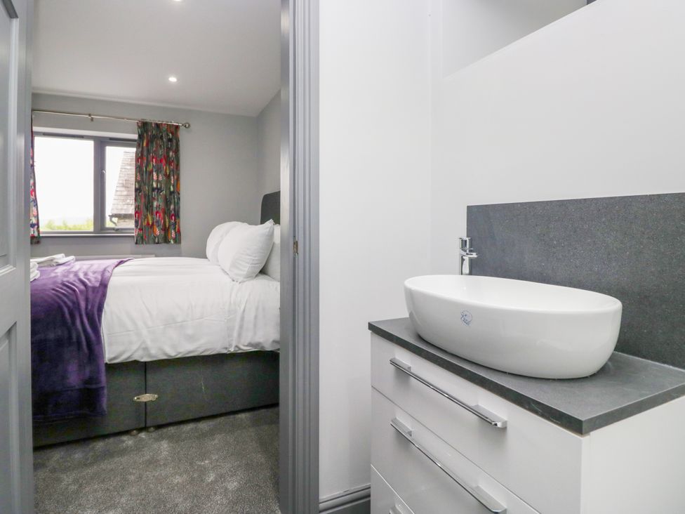 A bedroom with a bed and sink at Fell View Cottage Lambrigg near Kendal