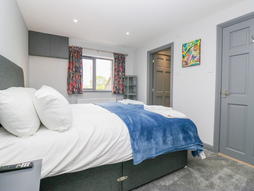 A bedroom with a bed and window at Fell View Cottage in Lambrigg near Kendal