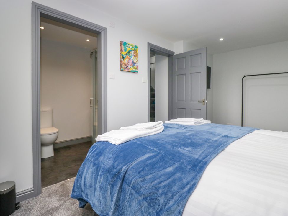 A bedroom with a bed and towels at Fell View Cottage Lambrigg near Kendal
