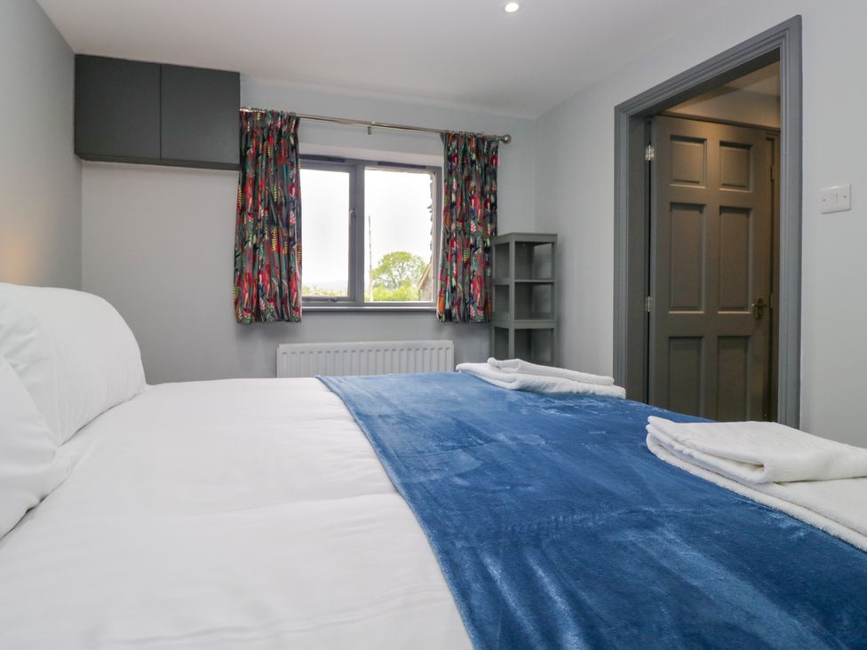 A bedroom with a bed and a window at Fell View Cottage Lambrigg near Kendal