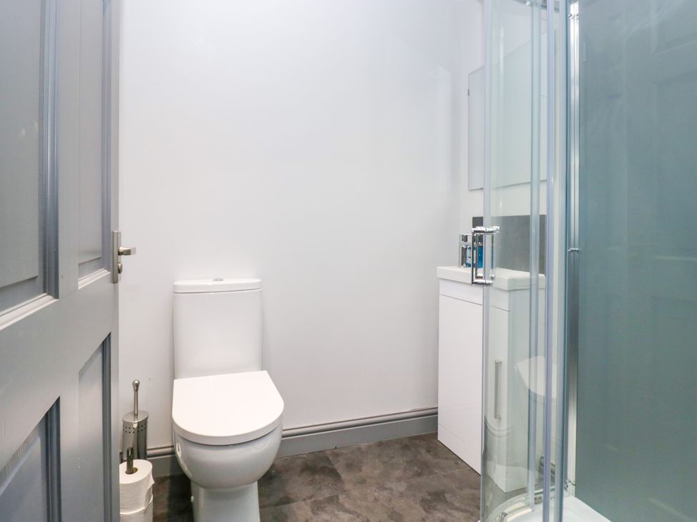 A bathroom with a toilet and shower in Fell View Cottage Lambrigg near Kendal