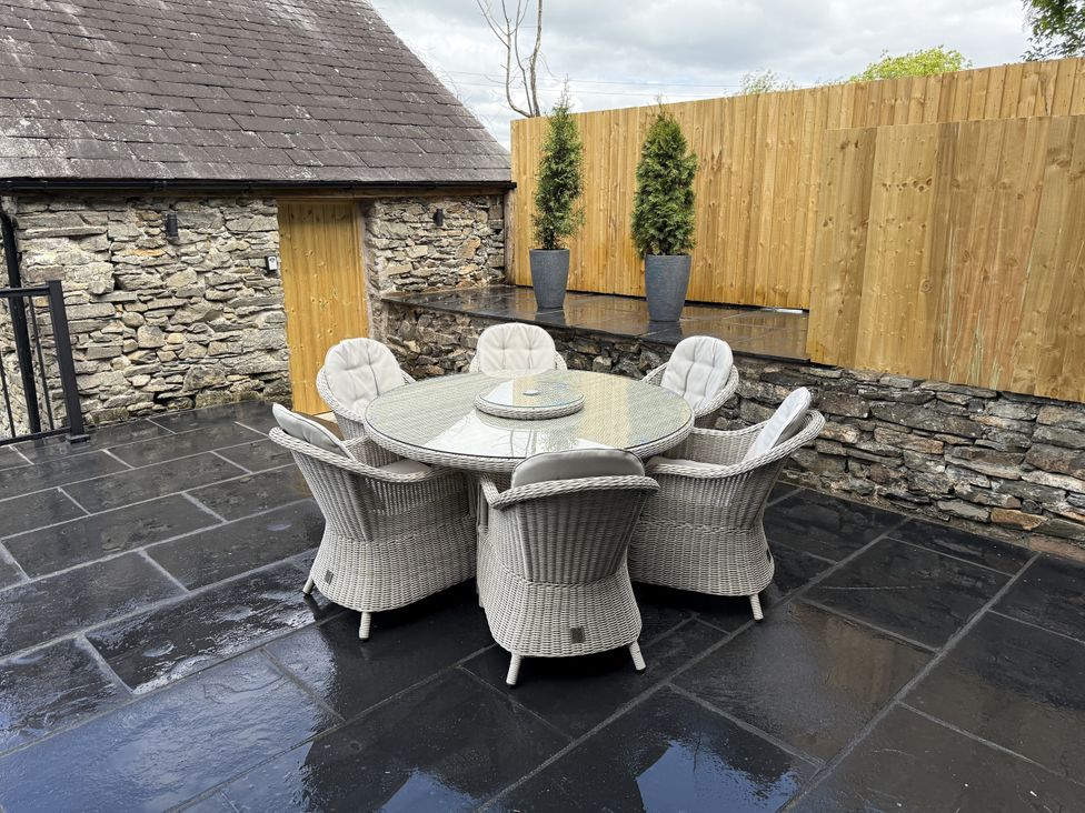 An outdoor patio with a table and chairs at Fell View Cottage Lambrigg near Kendal