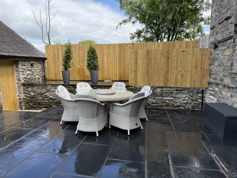 An outdoor seating area with a table and chairs at Fell View Cottage Lambrigg near Kendal