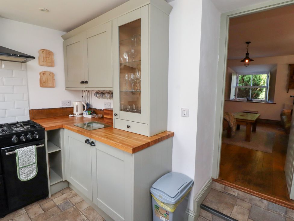 A kitchen with cabinets and stove at Bruno's Bothy Middleton near Belford