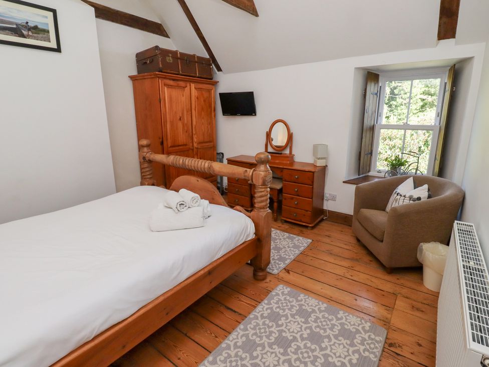 A bedroom with a bed and dresser at Bruno's Bothy Middleton near Belford