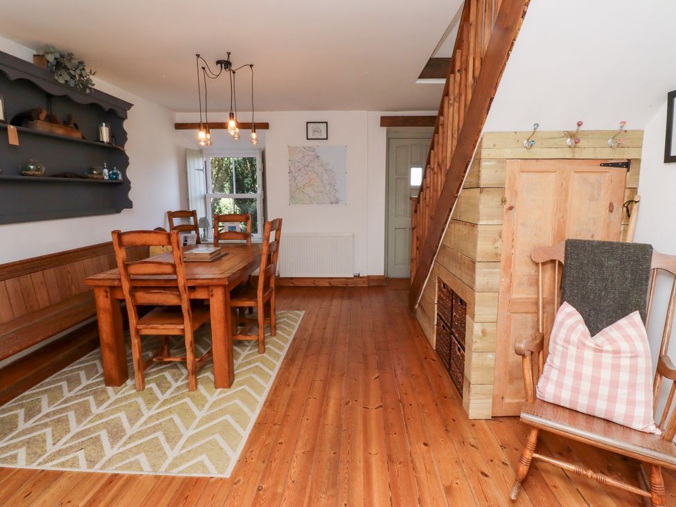 A dining room with a table and chairs at Kits Cottage Middleton near Belford