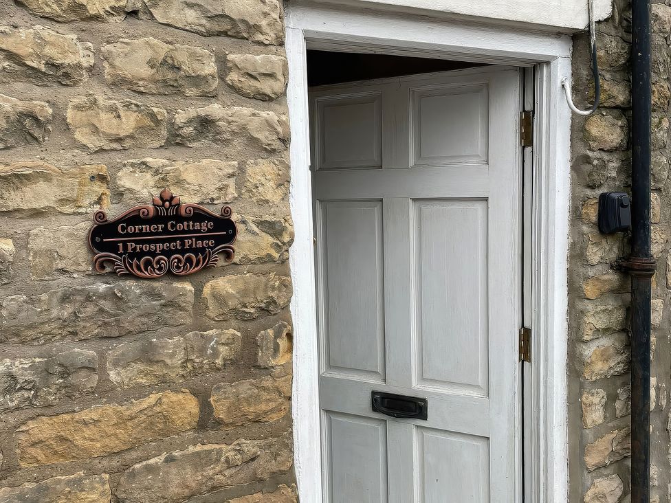 An entrance with a door and nameplate at Corner Cottage in Thornton Dale