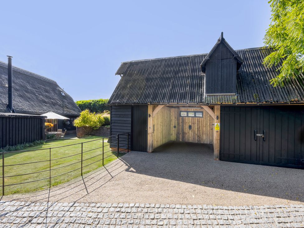 An entrance to a property with a gravel path and garden at The Hayloft in Chislet near Herne Bay