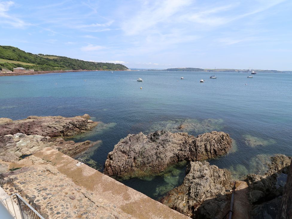 A coastal view with rocks and boats at Marina in 
