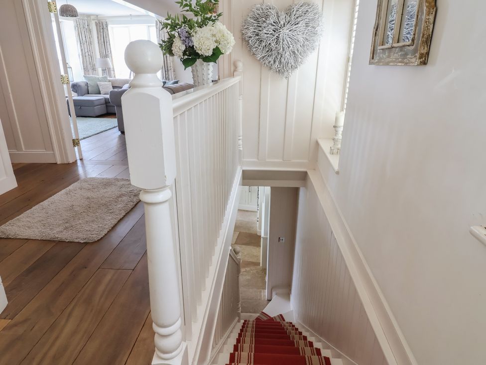 A view of stairs and hallway with floral decoration at Marina in 