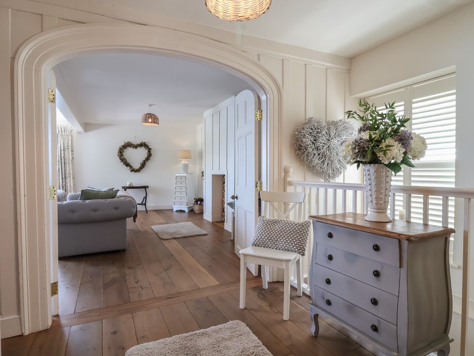 A living room with a sofa and flowers on a table at Marina