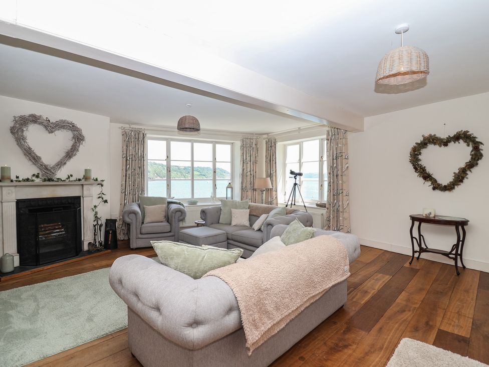 A living room with a fireplace and telescope at Marina