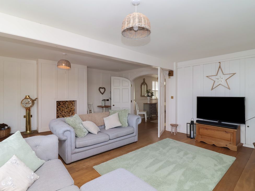 A living room with a sofa and television at Marina 