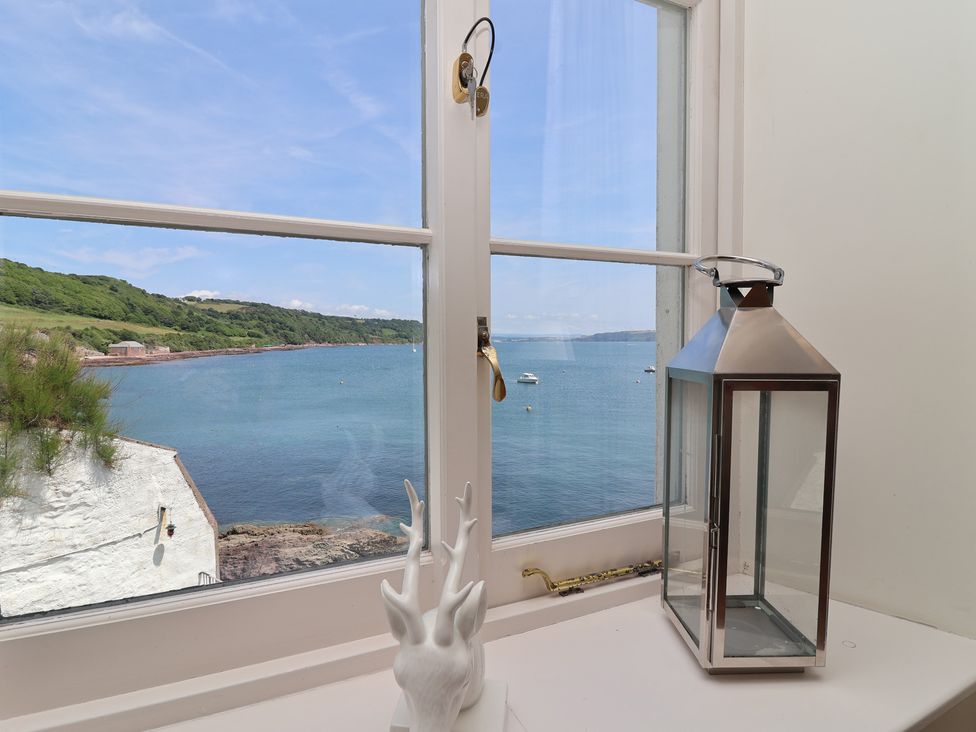 A window view with a lantern and sculpture at Marina