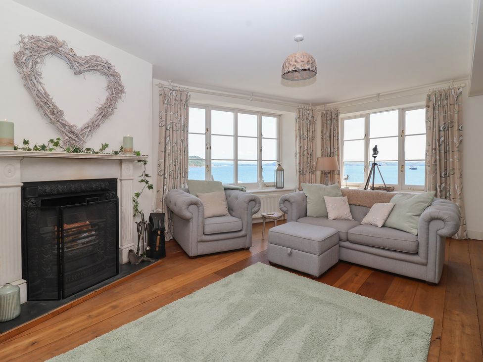 A living room with a fireplace and large windows at Marina in 