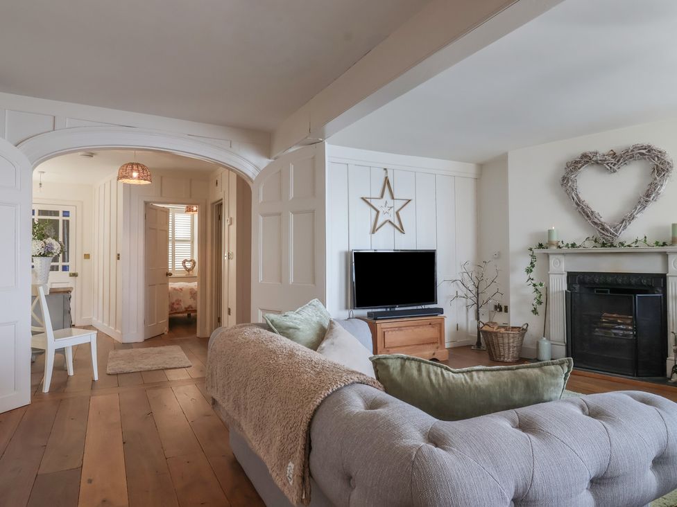 A living room with a sofa and television at Marina