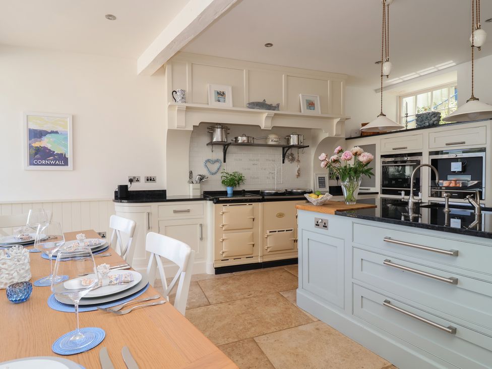 A kitchen with a dining table and chairs at Marina 